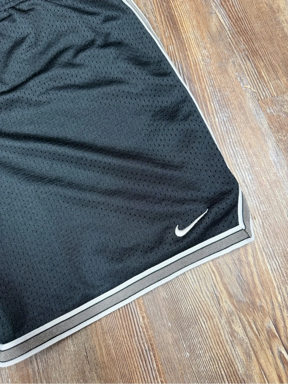 Vintage y2k Nike black shorts with white stripes on sides and hem, size S